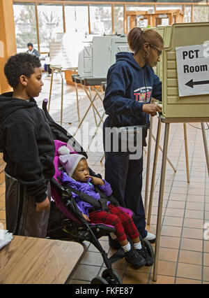 Detroit, Michigan, USA. 8th March, 2016. Children watch as their mother votes in Michigan's primary presidential election. Credit:  Jim West/Alamy Live News Stock Photo