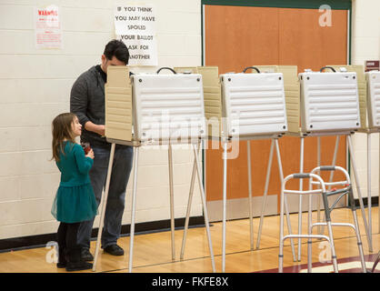 Detroit, Michigan, USA. 8th March, 2016. A girl watches as her father votes in Michigan's primary presidential election. Credit:  Jim West/Alamy Live News Stock Photo