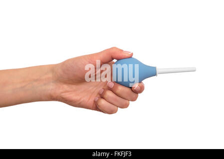 Enema in a hand on white background. Stock Photo