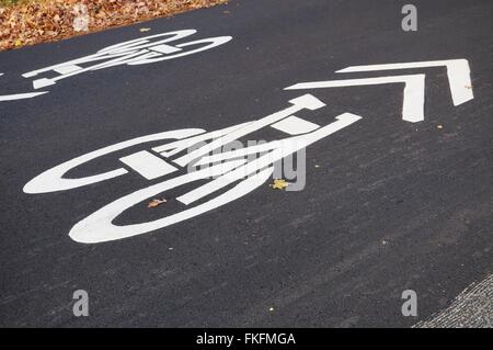 Sign representing a bicycle painted in white on the road asphalt to ...