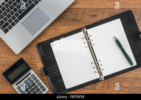 notebook and pen with calculator on the desk finance plan Stock Photo