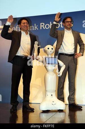 Tokyo, Japan. 8th Mar, 2016. Softbank Robotics president Fumihide Tomizawa (L) and Microsoft Japan president Takuya Hirano (R) mimic the pose of Softbank's humanoid robot Pepper as they announce a strategic collaboration in the field of cloud robotics in Tokyo on Tuesday, March 8, 2016. Pepper will offer customer service in store using Microsoft's Azur cloud platform. Credit:  Yoshio Tsunoda/AFLO/Alamy Live News Stock Photo