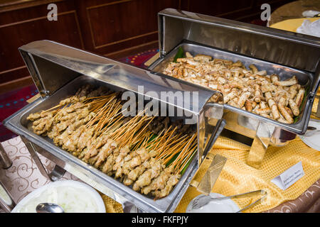 Asian style dishes of satay (meat sticks) and meat sausages. Stock Photo