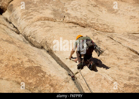 Man rock climbing, Hidden Valley, Joshua Tree National Park, California, USA Stock Photo