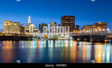 Hartford skyline and Founders Bridge at dusk. Hartford is the capital of Connecticut. Stock Photo