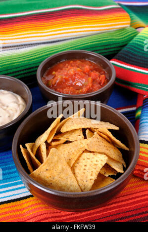 Mexican traditional serape blankets with salsa dip and tortilla chips. Stock Photo
