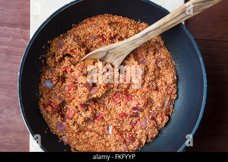 Vegan quinoa Sloppy Joe sauce in a cooking pot with wooden spoon Stock Photo