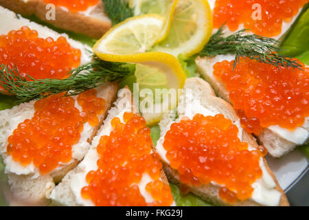 Fish, trout, chum salmon, humpback, a piece baked, grilled, with a slice of  lemon and lettuce Stock Photo - Alamy