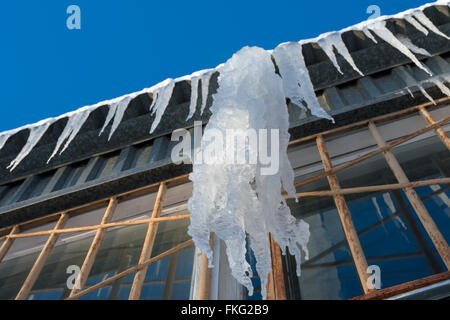 Large icicles hanging from the roof Stock Photo