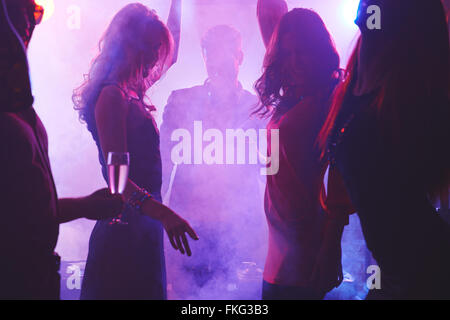 Group of dancing people in night club Stock Photo