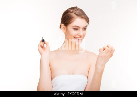 Portrait of beautiful young woman painting her nails over white background Stock Photo