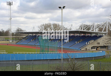 A lone,elderly runner practices on the athletics track at a deserted Crystal Palace Stadium. Stock Photo