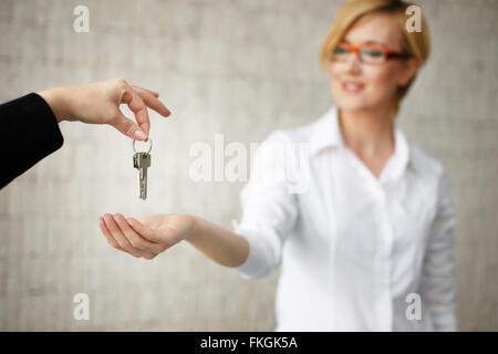 Happy owner passing keys from house in office, real estate Stock Photo