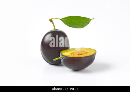 one and half plums on white background Stock Photo