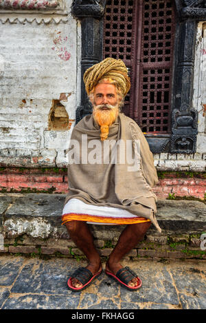 Wandering  sadhu baba (holy man) with traditional long hair in ancient Pashupatinath Temple Stock Photo