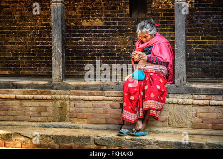 Old woman begs in the street of Bandipur Stock Photo