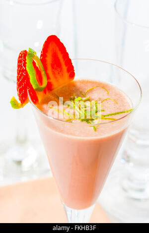 A strawberry and lime smoothie in a glass. Stock Photo