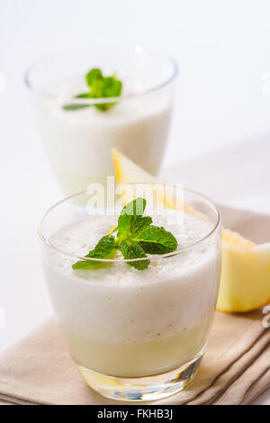 A fresh melon and mint smoothie, topped with mint leaves. Stock Photo