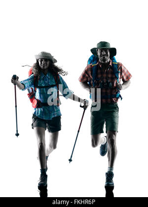 one caucasian couple trekker trekking running happy  in silhouette isolated on white background Stock Photo