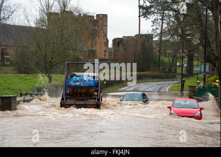 Kenilworth Castle, Warwickshire, UK. 09th Mar, 2016. Skip lorry speeds through ford overwhelming cars that have been abandoned in ford that has burst its banks neat to Kenilworth Castle, Kenilworth, Warwickshire. Credit:  Fraser Pithie/Alamy Live News Stock Photo