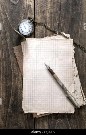 Vintage notebook and pocket watch on a wooden table Stock Photo - Alamy