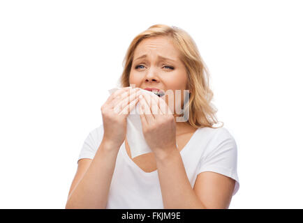 unhappy woman with paper napkin sneezing Stock Photo