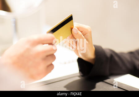 close up of hand giving credit card to seller Stock Photo