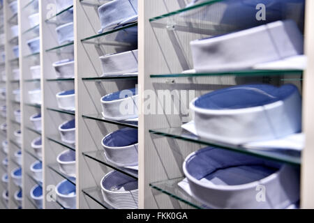 Lots of elegant shirts packed on shelves in a store Stock Photo