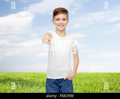 happy boy in white t-shirt pointing finger to you Stock Photo