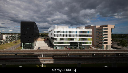 An exterior view of the Orestad College in Copenhagen, the dark sky can be seen in the distance. Stock Photo