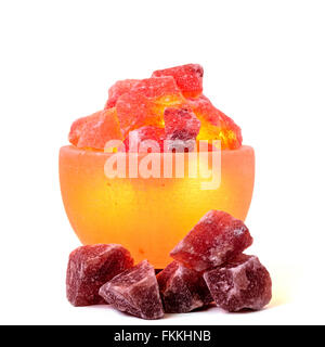 Turned on Himalayan pink salt lamp carved as a bowl isolated on white. Stock Photo
