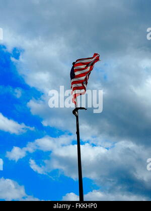 American flag on the blue clouded sky Stock Photo