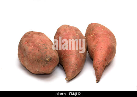 The sweet potato (Ipomoea batatas) is a large, starchy, sweet-tasting, tuberous root vegetable.  It is a staple food in parts of Africa and Asia. Stock Photo