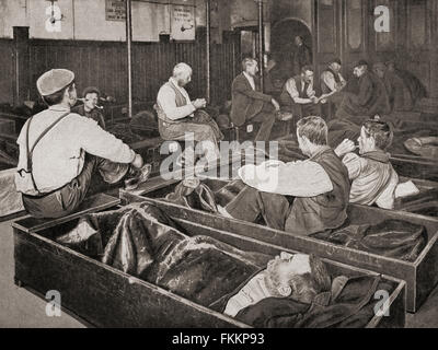 Men at the 'four penny coffin', aka 'coffin house', one of the first homeless shelters to be created for the people of central London, England, operated by the Salvation Army during the late 19th and early 20th centuries.  Customers received food and shelter, were allowed to lie down flat on their backs and sleep in a coffin shaped wooden box and given a tarpaulin for covering.   From Living London, published c.1901 Stock Photo