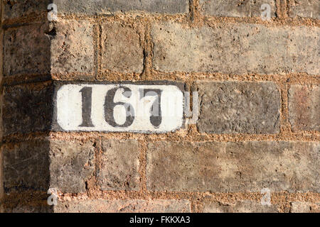House number 167 on black slate on a red brick wall Stock Photo - Alamy