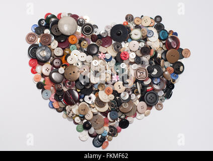 Buttons. Lots of buttons stacked in the form of heart on white background Stock Photo