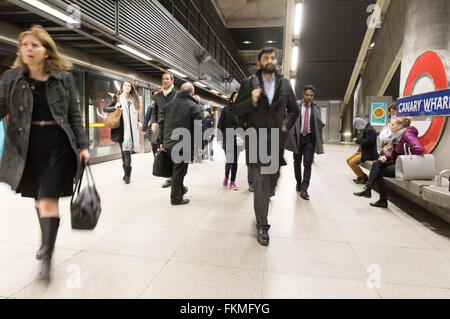 Office workers getting off at Canary Wharf station, Jubilee line, London Underground, London UK Stock Photo