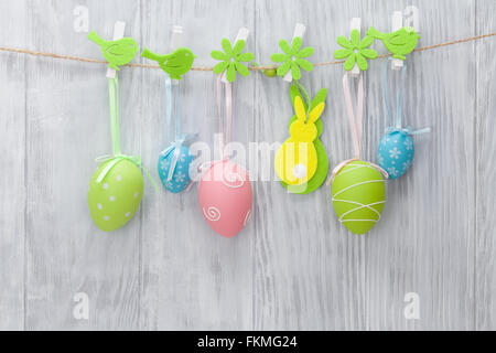 Colorful easter eggs and decor in front of wooden wall Stock Photo
