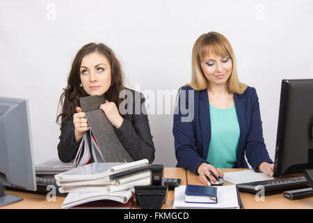 Female colleagues in the office, one hates to work, like a second job Stock Photo