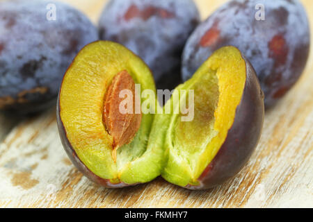 Fresh plum on wooden surface, closeup Stock Photo
