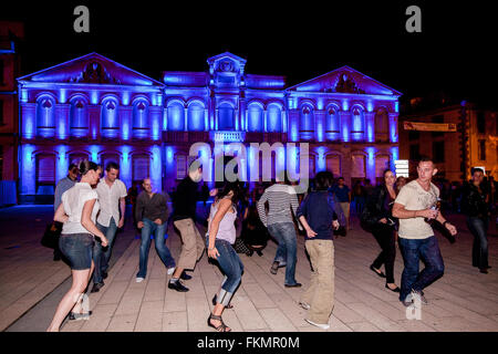 Local French dancing at Square Gambetta with lit Musee des Beaux Arts celebrating Bastille Day July 14th.Carcassonne,Aude,France Stock Photo