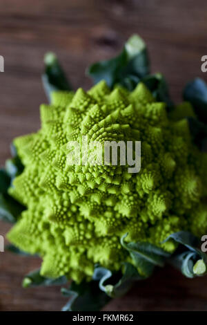 Close up of Romanesco broccoli on a wooden table Stock Photo