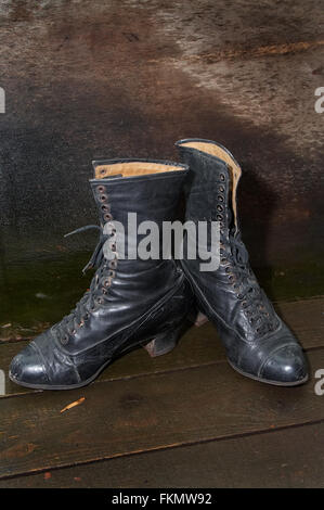 Old female boots on wooden to a floor Stock Photo