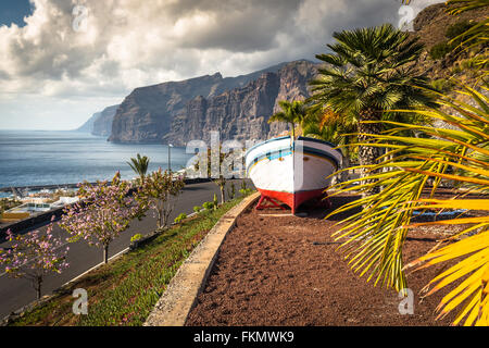 Colourful painted fishing boat near the ocean in Los Gigantes, Tenerife, Canary Islands, a picture postcard scenic view of the i Stock Photo