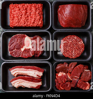 Different types of raw meat in plastic boxes packaging tray Stock Photo