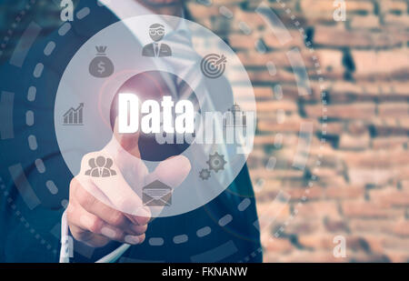 Businessman pressing a Data concept button. Stock Photo