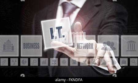 Businessman pressing an I.T. concept button. Stock Photo