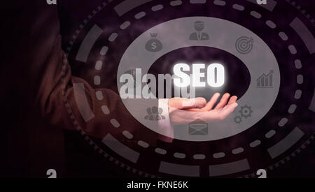 Businessman pressing an SEO concept button. Stock Photo