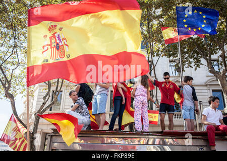 Anti-independence Catalan protestors carry Spanish flags during a demonstration for the unity of Spain on the occasion of the Sp Stock Photo