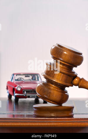 Concept image of classic red vintage 1969 MGB GT with auctioneers hammer Stock Photo